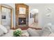 Inviting living room with a stone fireplace, hardwood floors, and open layout at 6634 Window Rock Ln, Morrison, CO 80465
