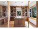 Bright home office featuring custom built-ins, wood floors, and a granite counter island at 6634 Window Rock Ln, Morrison, CO 80465