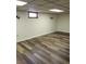 Basement area with wood-look flooring, recessed lighting and a small window at 609 S 1St Ave, Brighton, CO 80601