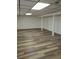 Spacious basement area featuring an open floor plan, modern flooring, and support beams at 609 S 1St Ave, Brighton, CO 80601