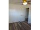 Bright bedroom featuring a ceiling fan, spacious closet, and modern wood-look flooring at 609 S 1St Ave, Brighton, CO 80601