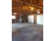 Spacious garage with exposed wood beams, two garage doors, and a window, offering ample storage and workspace at 609 S 1St Ave, Brighton, CO 80601