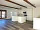 Open-concept kitchen featuring a large island with hardwood flooring at 609 S 1St Ave, Brighton, CO 80601