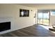 Living room showcasing modern flooring, a white brick fireplace, and a sunroom with sliding glass doors at 609 S 1St Ave, Brighton, CO 80601