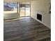 Cozy living room featuring modern floors, white brick fireplace, and sliding glass doors to the outside at 609 S 1St Ave, Brighton, CO 80601