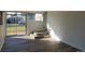 Bright sunroom featuring modern floors, white brick walls, steps and sliding glass doors to the yard at 609 S 1St Ave, Brighton, CO 80601