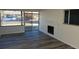 Inviting living room featuring a brick fireplace, wood floors, and large sliding glass doors to a street view at 609 S 1St Ave, Brighton, CO 80601