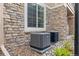 Exterior view showcasing modern air conditioning units for optimal temperature control at 4084 S Crystal Cir # 104, Aurora, CO 80014