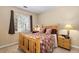 Comfortable bedroom with a wooden bed frame, soft carpet, and bright natural light at 4084 S Crystal Cir # 104, Aurora, CO 80014