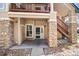 Welcoming entryway with stone accents, stairs, and easy access to the unit at 4084 S Crystal Cir # 104, Aurora, CO 80014