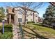 Charming condo exterior with stone accents, well-maintained landscaping and mature trees at 4084 S Crystal Cir # 104, Aurora, CO 80014