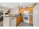 Bright kitchen with a breakfast bar, essential appliances, and ample counter space at 4084 S Crystal Cir # 104, Aurora, CO 80014