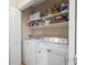 Convenient laundry room with washer, dryer and shelving for optimal storage at 4084 S Crystal Cir # 104, Aurora, CO 80014