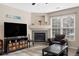 Bright living room with fireplace, flat screen television, and comfortable chair at 4084 S Crystal Cir # 104, Aurora, CO 80014