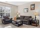 Bright and airy living room with comfortable seating and natural light from a window at 4084 S Crystal Cir # 104, Aurora, CO 80014
