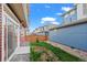 Cozy backyard with a small patch of grass between homes, and a view of blue sky at 10185 Xanadu St, Commerce City, CO 80022