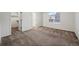 Bright bedroom featuring neutral carpet, closet, and a window offering natural light at 10185 Xanadu St, Commerce City, CO 80022