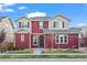 Charming two-story home with a well-manicured lawn showcases inviting curb appeal with a walkway to the front door at 10185 Xanadu St, Commerce City, CO 80022