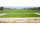 Expansive green space offers a scenic view with walking paths and neighborhood homes in the background at 10185 Xanadu St, Commerce City, CO 80022