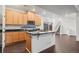 Well-equipped kitchen with island, granite countertops, stainless appliances and stairs to second story is move-in ready at 10185 Xanadu St, Commerce City, CO 80022