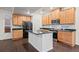 This kitchen features a center island with breakfast bar, granite countertops, and stainless steel appliances for modern living at 10185 Xanadu St, Commerce City, CO 80022