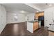 Bright kitchen with island, black appliances, and ample counter space offers a functional and stylish cooking area at 10185 Xanadu St, Commerce City, CO 80022
