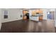 Open-concept living space and kitchen combo featuring modern finishes, abundant natural light, and seamless indoor-outdoor flow at 10185 Xanadu St, Commerce City, CO 80022