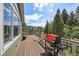 Large back deck perfect for entertaining with outdoor grill and wooded scenery at 20410 Brookmont Rd, Morrison, CO 80465