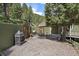 Outdoor patio area with gravel, green accent walls, and natural shade trees at 20410 Brookmont Rd, Morrison, CO 80465
