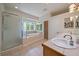 Bright bathroom showcasing a soaking tub, glass shower, and double sink vanity at 20410 Brookmont Rd, Morrison, CO 80465