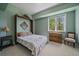 Comfortable bedroom with a full bed, natural light from the window and light green walls at 20410 Brookmont Rd, Morrison, CO 80465