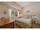 Cozy bedroom filled with natural light and decorated with floral bedding at 20410 Brookmont Rd, Morrison, CO 80465