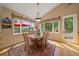 Cozy dining area with a wooden table, area rug, and backyard views at 20410 Brookmont Rd, Morrison, CO 80465