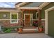 Cozy front porch with wooden door and decorative accents at 20410 Brookmont Rd, Morrison, CO 80465