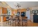 Kitchen featuring a large island with seating and hardwood floors at 20410 Brookmont Rd, Morrison, CO 80465