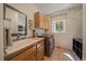 Functional laundry room with a utility sink, cabinet and modern appliances at 20410 Brookmont Rd, Morrison, CO 80465