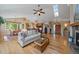 Open-concept living room and kitchen with hardwood floors, a fireplace, and abundant natural light at 20410 Brookmont Rd, Morrison, CO 80465