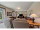 Living room with earth-toned couches, a TV, and large picture windows with natural light at 20410 Brookmont Rd, Morrison, CO 80465