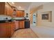 Convenient wet bar area with wood cabinetry and adjacent hallway at 20410 Brookmont Rd, Morrison, CO 80465