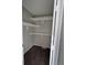 The carpeted walk-in closet features built-in shelving and neutral paint at 1719 S Ensenada Way, Aurora, CO 80017