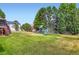 Spacious backyard with well-maintained lawn, playground set, and white fence at 3525 Rinn Valley Dr, Longmont, CO 80504