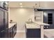 Basement wet bar with granite countertop, stainless steel sink and black cabinets at 3525 Rinn Valley Dr, Longmont, CO 80504