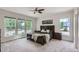 Spacious bedroom featuring a large bed, big windows, and carpet flooring at 3525 Rinn Valley Dr, Longmont, CO 80504