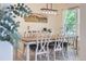Elegant dining room with a large table, stylish chairs, and a decorative light fixture at 3525 Rinn Valley Dr, Longmont, CO 80504