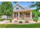 Charming home with a welcoming front porch, landscaped garden, and a well-maintained lawn at 3525 Rinn Valley Dr, Longmont, CO 80504