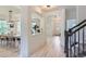 Hallway view with arched doorways, dining room to the left, staircase to the right at 3525 Rinn Valley Dr, Longmont, CO 80504