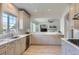 Modern kitchen with white cabinets, countertops, stainless steel appliances, and wood flooring at 3525 Rinn Valley Dr, Longmont, CO 80504