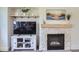 Living room showcasing a stone fireplace, decorative shelving, and a large TV at 3525 Rinn Valley Dr, Longmont, CO 80504