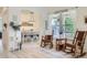 Cozy living room features wood floors, large windows, and comfortable rocking chairs at 3525 Rinn Valley Dr, Longmont, CO 80504