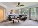 Living room featuring a brown leather sofa, large windows, and access to the kitchen at 3525 Rinn Valley Dr, Longmont, CO 80504